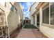 Side yard with artificial grass, stone pavers, and access to a covered patio at 3438 E Betsy Ln, Gilbert, AZ 85296