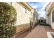 Paver walkway through landscaped side yard with covered patio and gate at 3438 E Betsy Ln, Gilbert, AZ 85296