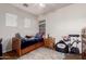 Bedroom with ceiling fan and twin bed and neutral paint at 3438 E Betsy Ln, Gilbert, AZ 85296