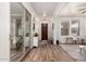 Bright foyer featuring wood floors, decorative mirror, and a seamless transition to the living area at 3438 E Betsy Ln, Gilbert, AZ 85296