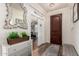 Inviting foyer boasts wood floors, decorative mirror, and stylish console table at 3438 E Betsy Ln, Gilbert, AZ 85296