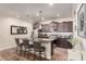 Well-lit kitchen features an island with barstool seating and granite counters, complemented by dark wood cabinetry at 3438 E Betsy Ln, Gilbert, AZ 85296