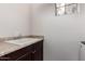 Bright laundry area sink with a granite countertop and dark wood cabinetry at 3438 E Betsy Ln, Gilbert, AZ 85296