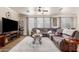 Comfortable living room with ample seating, a ceiling fan, and a seamless transition to the dining area at 3438 E Betsy Ln, Gilbert, AZ 85296
