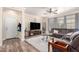 Spacious living room featuring a ceiling fan, entertainment center, and a comfortable sectional sofa at 3438 E Betsy Ln, Gilbert, AZ 85296
