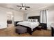 A bedroom featuring a dark wood bed frame, matching furniture set, and neutral walls and carpet at 3438 E Betsy Ln, Gilbert, AZ 85296