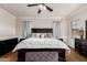 A bedroom featuring a dark wood bed frame, matching furniture set, and neutral walls and carpet at 3438 E Betsy Ln, Gilbert, AZ 85296