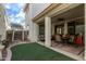Covered patio with textured columns, ceiling fan, and a cozy outdoor seating area at 3438 E Betsy Ln, Gilbert, AZ 85296