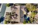 An aerial view of the desert home with a tile roof shows the backyard with a pool and lush desert landscaping at 41601 N River Bend Rd, Anthem, AZ 85086