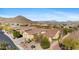Aerial shot of a neighborhood with mountain views showcasing lush desert landscaping at 41601 N River Bend Rd, Anthem, AZ 85086