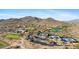 Expansive aerial view showcasing the community, golf course, tennis courts, and scenic mountain backdrop at 41601 N River Bend Rd, Anthem, AZ 85086