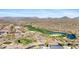 Picturesque aerial view of golf course highlighting lush green, a serene pond, and desert landscape at 41601 N River Bend Rd, Anthem, AZ 85086