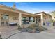 Entertain on the covered patio with spa, seating, and outdoor grill, surrounded by desert landscaping at 41601 N River Bend Rd, Anthem, AZ 85086