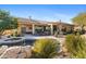 A tranquil backyard features a rock water feature flowing into the pool and spa with a covered patio at 41601 N River Bend Rd, Anthem, AZ 85086