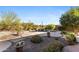 A backyard pool with a waterfall feature surrounded by lush landscaping, stone, and potted plants create a relaxing atmosphere at 41601 N River Bend Rd, Anthem, AZ 85086
