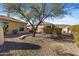 Backyard with desert landscaping and neighboring home at 41601 N River Bend Rd, Anthem, AZ 85086