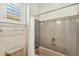 Bathroom with a shower/tub combo, classic fixtures, and tiled walls at 41601 N River Bend Rd, Anthem, AZ 85086