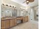 Spacious bathroom with double vanities, tile countertops, and decorative mirror at 41601 N River Bend Rd, Anthem, AZ 85086