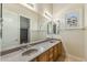 Bathroom featuring double sinks with a large mirror and bright natural light from the window at 41601 N River Bend Rd, Anthem, AZ 85086