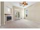 An expansive bedroom features a cozy fireplace, neutral tones, plush carpeting, and a ceiling fan for added comfort at 41601 N River Bend Rd, Anthem, AZ 85086