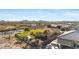 Aerial view of a desert home with lush landscaping, outdoor living, and beautiful views of the surrounding landscape at 41601 N River Bend Rd, Anthem, AZ 85086