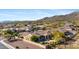 A desert home in the foreground has beautiful mountain views, lush landscaping and a private backyard at 41601 N River Bend Rd, Anthem, AZ 85086