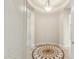 Foyer featuring decorative tile inlay, neutral walls, and an elegant light fixture at 41601 N River Bend Rd, Anthem, AZ 85086
