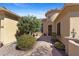 A charming front entrance with a stone walkway, lush landscaping, and a decorative wrought iron security door, a warm welcome at 41601 N River Bend Rd, Anthem, AZ 85086