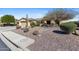Beautifully landscaped front yard with desert plants, rocks and manicured shrubs at 41601 N River Bend Rd, Anthem, AZ 85086