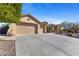 A three-car garage with a long driveway offering ample parking space and curb appeal for this well-maintained home at 41601 N River Bend Rd, Anthem, AZ 85086