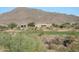 Beautiful golf course and desert landscape with homes and a mountain backdrop at 41601 N River Bend Rd, Anthem, AZ 85086