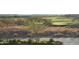 Picturesque golf course view with desert landscaping and distant houses at 41601 N River Bend Rd, Anthem, AZ 85086