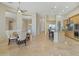 Open-concept kitchen and dining area with tiled floors and bar seating at 41601 N River Bend Rd, Anthem, AZ 85086