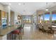 Open kitchen and dining area with large windows and a view of the backyard at 41601 N River Bend Rd, Anthem, AZ 85086