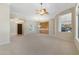 Spacious living room with arched doorways and a custom built-in cabinet at 41601 N River Bend Rd, Anthem, AZ 85086