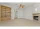 Comfortable living room with built-in bookshelves, fireplace, and neutral carpet at 41601 N River Bend Rd, Anthem, AZ 85086