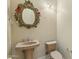 Elegant powder room with a decorative mirror and sconces adding a touch of charm at 41601 N River Bend Rd, Anthem, AZ 85086