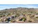 Desert community street view with mountain views and lush green desert landscaping at 41601 N River Bend Rd, Anthem, AZ 85086