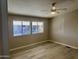 Bright bedroom with two windows and light-colored floors and a ceiling fan at 420 S 98Th Way, Mesa, AZ 85208