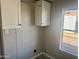 Functional laundry area with wall cabinets, a hanging rod, and a convenient window at 420 S 98Th Way, Mesa, AZ 85208