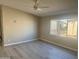 Spacious living room featuring modern flooring and a ceiling fan for comfortable living at 420 S 98Th Way, Mesa, AZ 85208