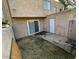 Backyard featuring sliding glass door and white door, and a small grass area at 4258 N 68Th Ln, Phoenix, AZ 85033