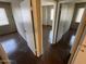 Bedrooms with wood floors, white walls, and doors showing the layout of the home at 4258 N 68Th Ln, Phoenix, AZ 85033