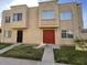 Two-story home featuring a stucco facade, red double-door entry, and well-maintained front lawn at 4258 N 68Th Ln, Phoenix, AZ 85033