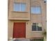 Close-up of a two-story home with a stucco facade and a red double-door entry at 4258 N 68Th Ln, Phoenix, AZ 85033