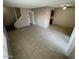 Living room featuring tile flooring, gray walls, open staircase, and access to kitchen area at 4258 N 68Th Ln, Phoenix, AZ 85033