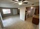 Open-concept living room with tile flooring connecting to the kitchen with stainless steel appliances at 4258 N 68Th Ln, Phoenix, AZ 85033