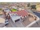 Aerial view of home with red tile roof showcasing desert landscaping, pool, and a spacious driveway at 5607 E Enrose St, Mesa, AZ 85205