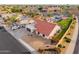 Bird's-eye view of a home, revealing the tile roof, desert landscape, a swimming pool, and neighborhood at 5607 E Enrose St, Mesa, AZ 85205