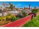 Great backyard featuring vibrant flower beds, outdoor seating area, grill, and a well-maintained lawn at 5607 E Enrose St, Mesa, AZ 85205